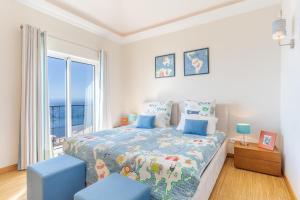 a bedroom with a bed and a large window at Villa Bougainvillea Palheiro Village by HR Madeira in Funchal +45 photos