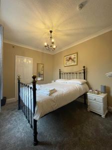 a bedroom with a large bed and a chandelier at The Seven Stars in Durham