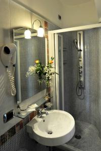 a bathroom with a sink and a shower with flowers at E Poi...Ravello in Ravello