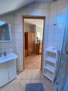 a bathroom with a sink and a toilet and a mirror at Pokoje Pod Kasztanami Jantar in Jantar +49 photos