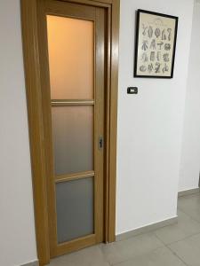 a wooden door with glass panels in a room at La Baita In Città in Caserta
