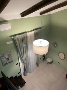 a living room with a lamp and a curtain at La Baita In Città in Caserta