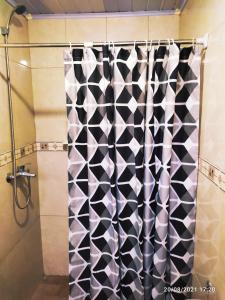 a shower with a black and white shower curtain at Las Mozitas 1 in Barra del Chuy