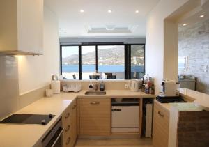 A kitchen or kitchenette at Penthouse -Breathtaking sea view-Just on the beach