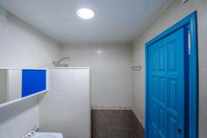 a bathroom with a toilet and a blue door at Casa Rosana by MarCalma in Miami Platja +23 photos