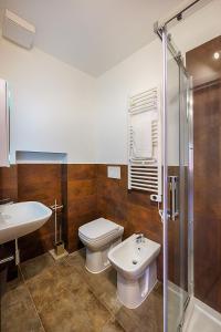 a bathroom with a toilet and a sink and a shower at ELEROOM in Siena +54 photos