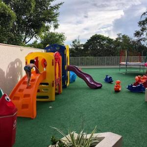 a playground with a child playing on a slide at Park Veredas Flat Service Rio Quente - GO Apto 416 in Rio Quente