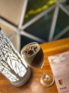 a glass of wine sitting on top of a table at Glamping el Porvenir RNT 10601 in Manta +18 photos