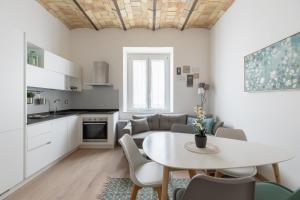 a kitchen and living room with a table and chairs at iFlat Saint Peter Bright Apartment in Rome