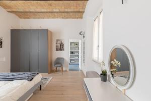 a bedroom with a bed and a mirror at iFlat Saint Peter Bright Apartment in Rome