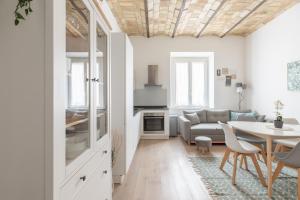 a living room with a table and a couch at iFlat Saint Peter Bright Apartment in Rome +13 photos
