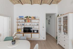 a living room with a table and a tv at iFlat Saint Peter Bright Apartment in Rome