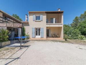a house with a blue ping pong table in front of it at Superb house with pool near the Luberon in Oppède