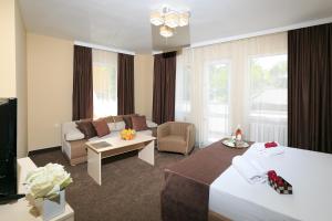 a hotel room with a bed and a couch at HOTEL THE WHITE HOUSE Plovdiv in Plovdiv