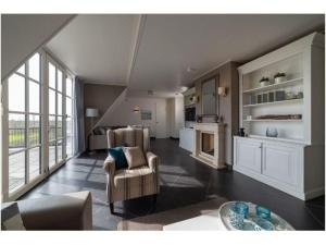un ampio soggiorno con divano e tavolo di Luxury holiday home in Colijnsplaat with a private pool hot tub and sauna a Colijnsplaat