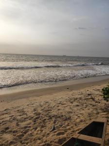 an empty beach with the ocean in the background at Maison MIDAREA in Kribi