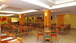 a restaurant with wooden tables and chairs in it at Hípico inn Hotel in Poza Rica de Hidalgo