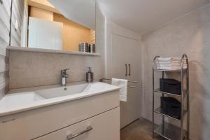 biała kuchnia ze zlewem i wieszakiem na ręczniki w obiekcie Apartman Bora 1 w Novalji