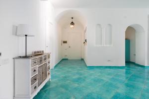 a room with a blue tile floor and white walls at La Torre del Vervece in Massa Lubrense +38 photos