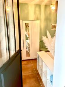 a dressing room with a door and a mirror at Studio Muret atypique in Muret