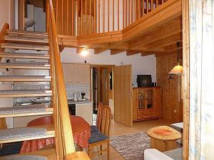 a living room with a staircase and a kitchen at Ferienhaus Nr 13B1, Feriendorf Hagbügerl, Bayr Wald in Waldmünchen