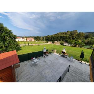 a view of a patio with chairs and a field at VADOS - LA COLINA in Arnuero