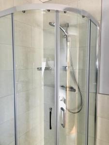a shower with a glass door in a bathroom at Leanna's Lodge, Keshcarrigan in Leitrim