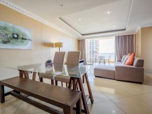 a living room with a glass table and a couch at The Sails Apartment 2 Bed 2 Bath Seaview Apartment - C5 in Durban