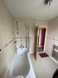 a large white bath tub in a bathroom at 2BR 15 min to BHX Airport 5 min to Heartlands in Birmingham