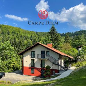 a villa in the mountains with a car parked in front of it at Apartamenty Carpe Diem in Ustroń