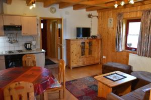 a kitchen and living room with a table in a room at Ferienhaus Nr 10B2, Feriendorf Hagbügerl, Bayr Wald in Waldmünchen