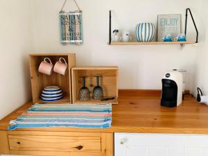 a kitchen counter with a wooden dresser with dishes on it at Anthony's Sea Stay in Marsaxlokk