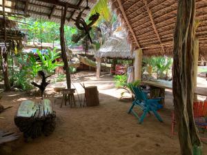 a room with a table and chairs in a hut at Ensueños big rooms in Little Corn Island