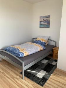 a bed in a room with a bed frame at Apartment 22 in Kirchhain