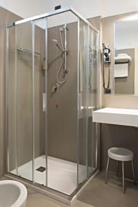 a shower with a glass door in a bathroom at Hotel Spinelli in Viareggio