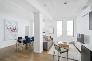 a living room with a couch and a table and chairs at Bakan- Quartier des Congres, Convention District in Montreal +118 photos