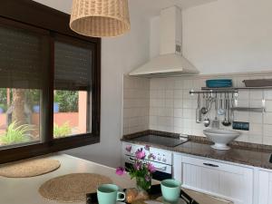 a kitchen with a counter with a sink and a stove at APARTMENT LA PEÑA ROJO WIFI in Tarifa