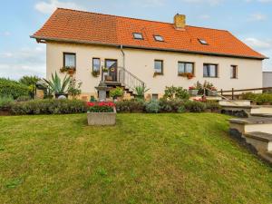 a large house with an orange roof at Apartment with balcony in Harz Mountains in Cattenstedt