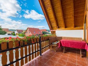a patio with a table and a wooden fence at Apartment with balcony in Harz Mountains in Cattenstedt