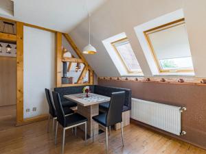 a dining room with skylights and a table and chairs at Apartment with balcony in Harz Mountains in Cattenstedt