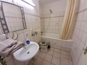 łazienka z umywalką, wanną i toaletą w obiekcie Apartment with balcony near D sseldorf w mieście Neuss