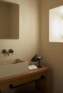 a bathroom with a sink and a mirror at PAROCKS Luxury Hotel & Spa in Ambelas