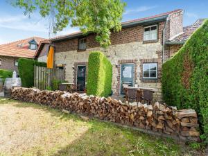 a house with a pile of fire wood in front of it at Apartment in Ubachsberg near Limburg Trails in Voerendaal