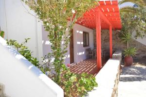 a porch of a house with an orange roof at Paradisia Villas in Naxos Chora