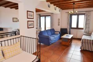 a living room with a blue couch and a table at Paradisia Villas in Naxos Chora