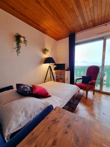 a bedroom with a bed and a desk and a chair at Studio avec superbe vue 5min à pied des Thermes in Bagnoles de l'Orne