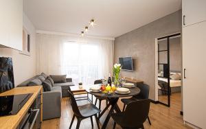 kuchnia i salon ze stołem i krzesłami w obiekcie Apartament Nakielska 46a lux 40m2 w Bydgoszczy