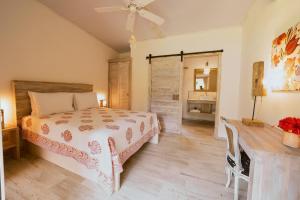 a bedroom with a bed and a table and a mirror at Sonora Jungle & Yoga Retreat in Puerto Viejo