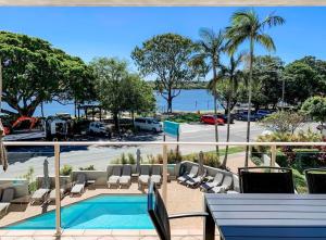 a balcony with a view of a pool and a parking lot at Regatta Noosa in Noosaville