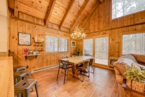 a dining room with a table and a couch at Coyote Cabin in Angel Fire +18 photos